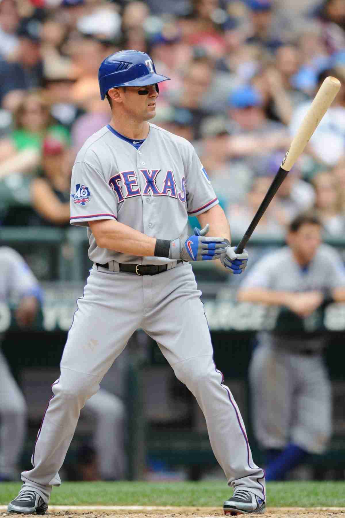 Former baseball player Michael Young looks over a display case